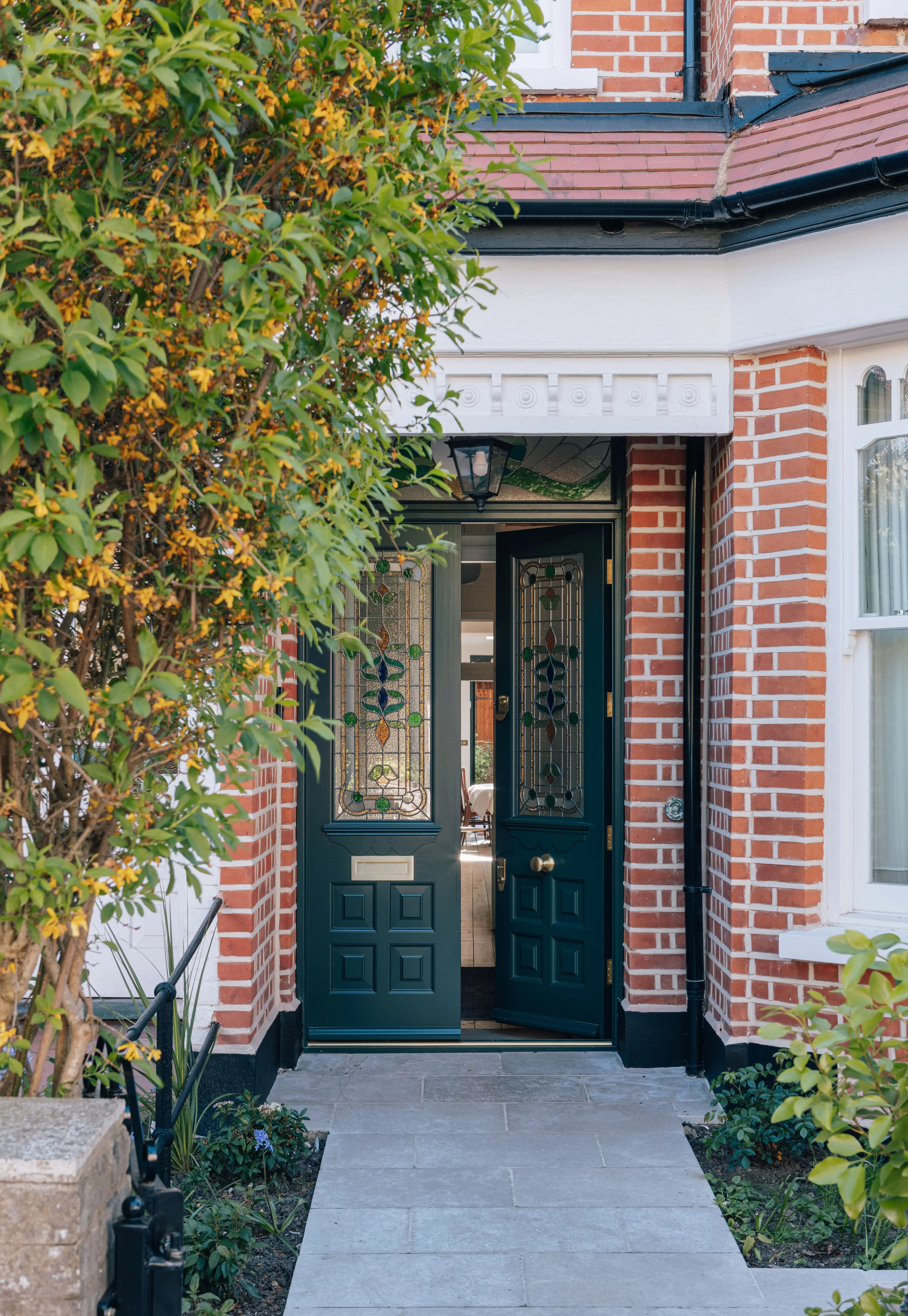 Period London home entrance with original brickwork, decorative glazing and carefully integrated architectural details by ZOARC Architecture.